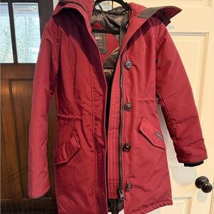 Canada Goose Burgundy Jacket with Hood. Black Interior, pockets inside and out.